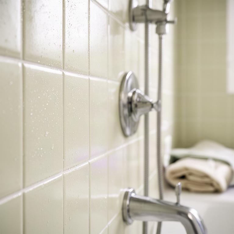 Fresh bathroom with revived grout lines and mildew removed from pale shower tile